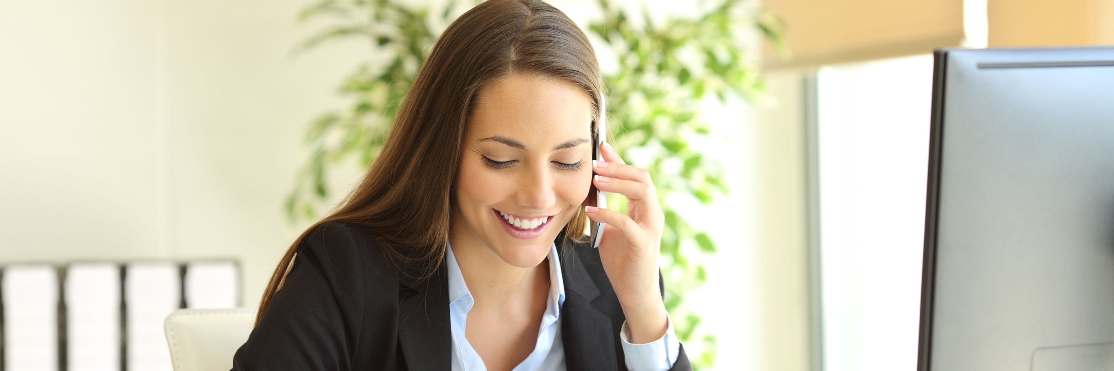 Businesswoman calling on phone and taking notes