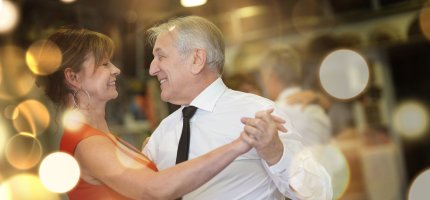 Romantic senior couple dancing together at dance hall