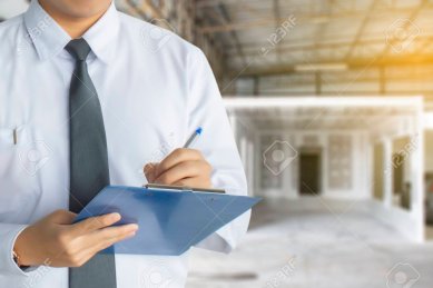 Male engineer inspection writing in factory With note on notepad